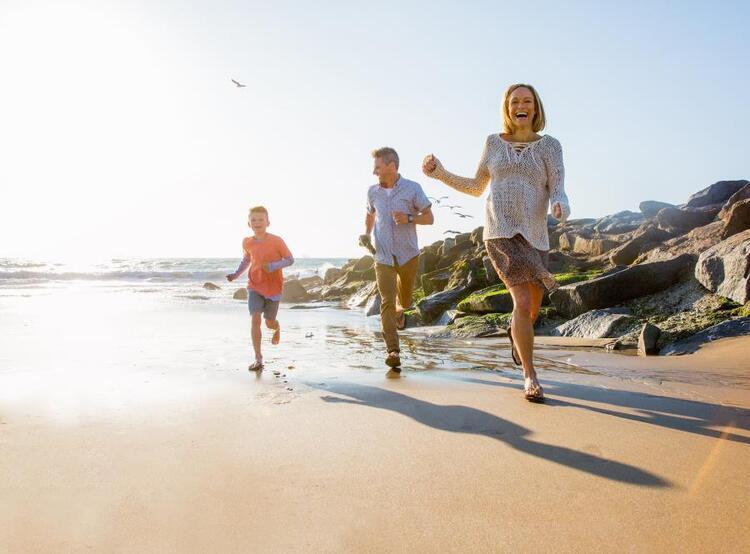 family running on beach